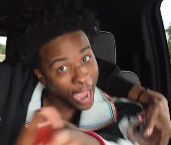 Nitro Camden leaning toward the camera with a surprised expression inside a car during an IRL stream.