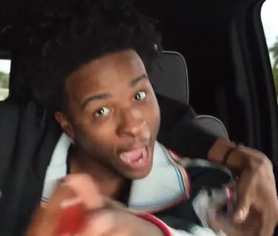 Nitro Camden leaning toward the camera with a surprised expression inside a car during an IRL stream.