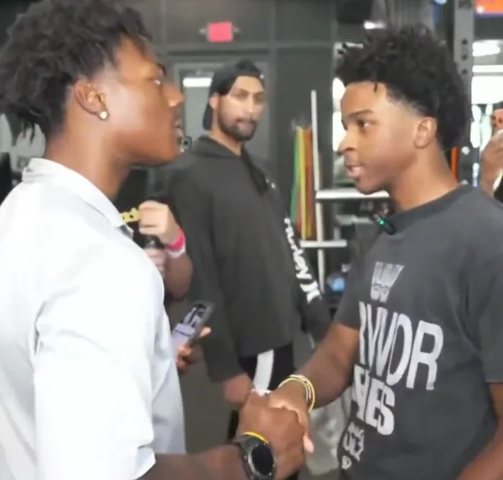 IShowSpeed and Nitro Camden clasping hands inside a gym during a livestream.