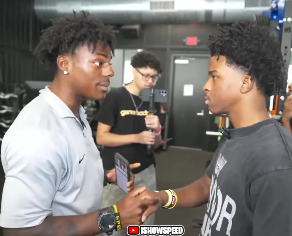 IShowSpeed and Nitro Camden holding a handshake inside a gym during a livestream.